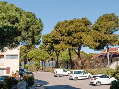 a group of cars parked in a parking lot at T2 avec Piscine à Gruissan - Proche Plage et Commerces - FR-1-409A-14 in Gruissan