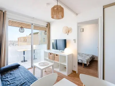 a living room with a couch and a tv at Appartement Gruissan - Parking Privé, Animaux Acceptés - FR-1-409A-16 in Gruissan