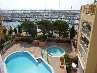 a view of a swimming pool on a building with a marina at Appartement Gruissan - Parking Privé, Animaux Acceptés - FR-1-409A-16 in Gruissan