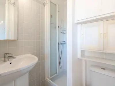 a white bathroom with a sink and a shower at Appartement lumineux à Gruissan, 2 chambres, proche plage, parking sécurisé, mini-box WIFI, non-fumeur - FR-1-409A-15 in Gruissan