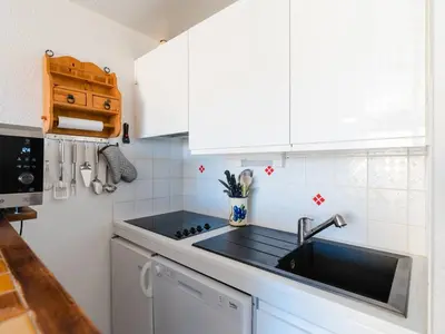 a kitchen with a sink and a stove top oven at Appartement lumineux à Gruissan, 2 chambres, proche plage, parking sécurisé, mini-box WIFI, non-fumeur - FR-1-409A-15 in Gruissan