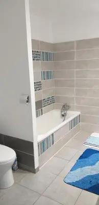 a bathroom with a bath tub and a toilet at Chez Reinette in Capendu
