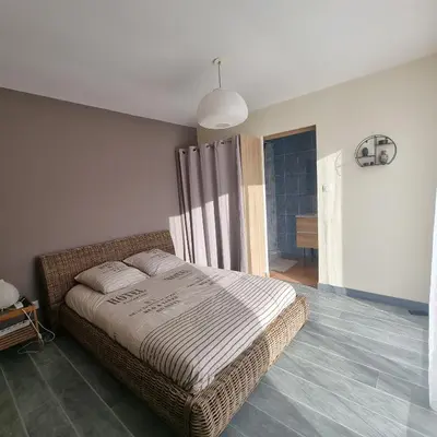 a bedroom with a bed in a room at Chambre avec piscine partagée in Marcorignan