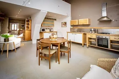 a kitchen and dining room with a table and chairs at La Chasse au Bonheur Piscine-Wifi in Rieux-Minervois