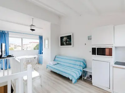 a white room with a bed and a kitchen at Duplex lumineux à Gruissan avec parking, proche plage et port - FR-1-409A-11 in Gruissan