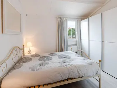 a bedroom with a bed in a room with a window at Duplex lumineux à Gruissan avec parking, proche plage et port - FR-1-409A-11 in Gruissan