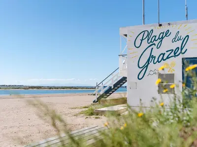 a building on the beach with a sign on it at Duplex lumineux à Gruissan avec parking, proche plage et port - FR-1-409A-11 in Gruissan