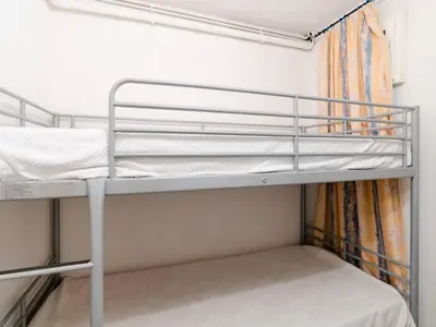 a bunk bed room with two bunk beds and a curtain at Duplex lumineux à Gruissan avec parking, proche plage et port - FR-1-409A-11 in Gruissan