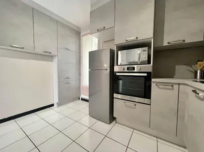 a kitchen with a refrigerator and a microwave at Duplex 70m2 - Vue Cité Mediévale - Parking gratuit in Carcassonne