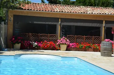 a swimming pool in front of a house with flowers at Le Havre Guest room in the heart of the vineyard no2307 in Badens