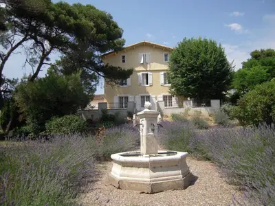 a stone birdbath in a garden in front of a house at Le Havre Guest room in the heart of the vineyard no2307 in Badens