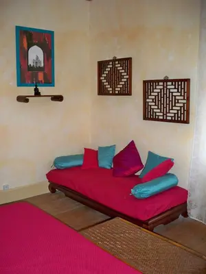a bed in a room with pink and blue pillows at Hong Kong Guest room in the heart of the vineyard no69 in Badens