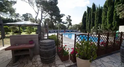 a patio with a table and a fence with a pool at Hong Kong Guest room in the heart of the vineyard no69 in Badens