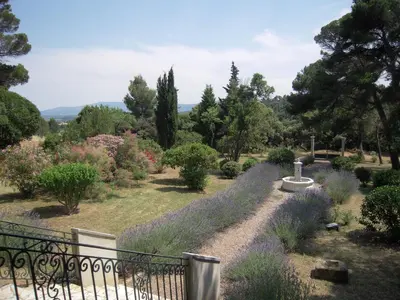 a garden with purple flowers and a fence at Londres guest room in the heart of the vineyard no123 in Badens