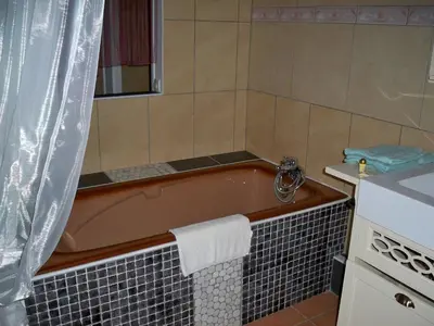 a bathroom with a bath tub and a sink at Wellington Guest Room in the heart of the vineyard no1205 in Badens
