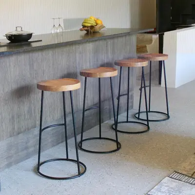 three bar stools in front of a kitchen counter at L'écurie de Gamin - gîte 4 pers. dans le Minervois in Aigues-Vives
