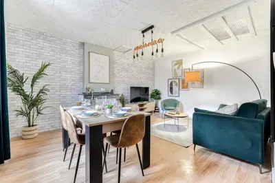 a dining room and living room with a table and chairs at les Bulles Occitanes - tout à pied in Carcassonne
