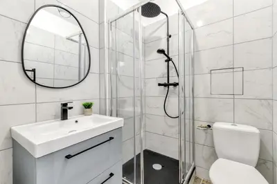 a bathroom with a shower and a sink and a mirror at les Bulles Occitanes - tout à pied in Carcassonne