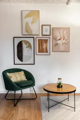 a living room with a green chair and a table at les Bulles Occitanes - tout à pied in Carcassonne