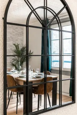 a dining room with a large black framed mirror at les Bulles Occitanes - tout à pied in Carcassonne