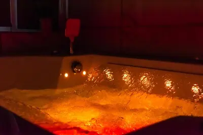 a bath tub filled with fire in a bathroom at les Bulles Occitanes - tout à pied in Carcassonne