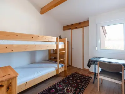 a bedroom with two bunk beds and a desk at Villa spacieuse à Gruissan, 4 chambres, jardin privé, clim, proche plage, idéal familles/amis - FR-1-409A-18 in Gruissan