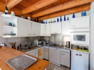 a kitchen with white cabinets and a wooden ceiling at Villa spacieuse à Gruissan, 4 chambres, jardin privé, clim, proche plage, idéal familles/amis - FR-1-409A-18 in Gruissan