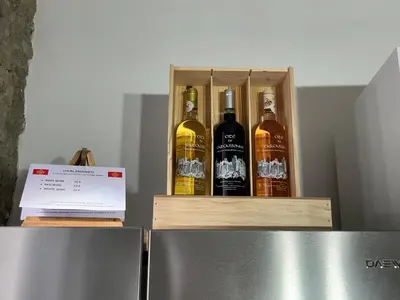 a box of bottles of alcohol sitting on top of a refrigerator at La Cité Secrète in Carcassonne