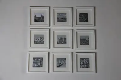 a group of framed pictures on a wall at La Cité Secrète in Carcassonne