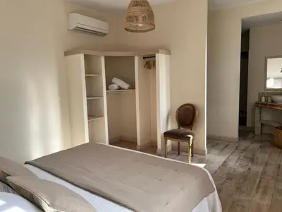 a bedroom with a bed and a chair at La Cité Secrète in Carcassonne