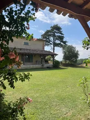 a house with a large yard with a grassy field at Lauraguel Gîte in Mourvilles-Hautes