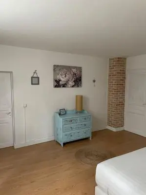 a bedroom with a bed and a blue dresser in it at Lauraguel Gîte in Mourvilles-Hautes