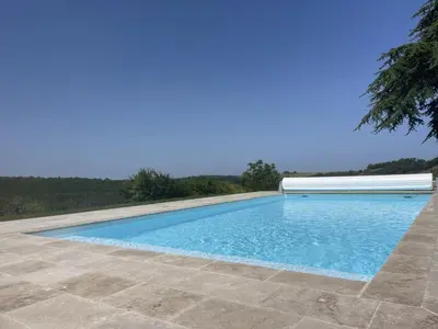 a swimming pool with blue water in a yard at Lauraguel Gîte in Mourvilles-Hautes