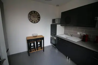 a living room with a couch and a table at NARBONNE : SUPER APPARTEMENT DE QUALITÉ in Narbonne