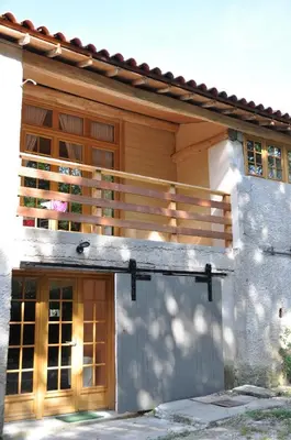 a house with a deck on the side of it at Gîte Le Ribet in Lempaut