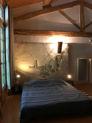 a bedroom with a bed in a room at Gîte Le Ribet in Lempaut