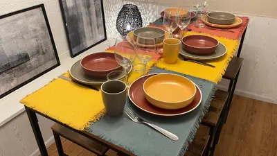 a table with plates and wine glasses on it at L'Alcove in Carcassonne