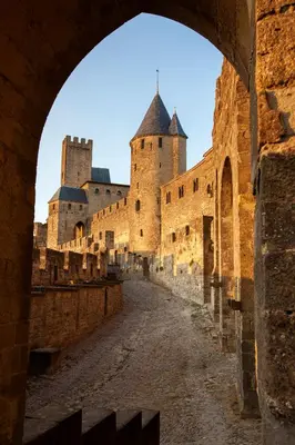 a view of a castle through an archway at L'Alcove in Carcassonne