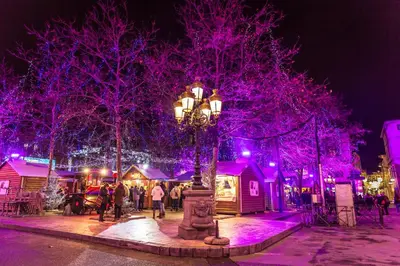 a christmas market in a city with purple lights at L'Alcove in Carcassonne