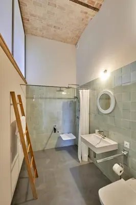 a bathroom with a sink and a shower and a toilet at Dépendance de Sibra in Lagarde