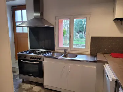 a kitchen with a sink and a stove and a window at DOMAINE DE POULHARIES - Carignan in Carcassonne