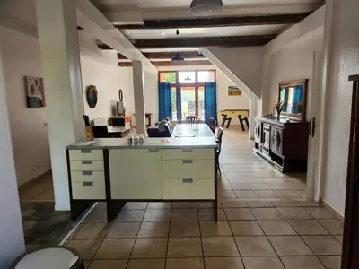 a kitchen with an island in the middle of a room at DOMAINE DE POULHARIES - Carignan in Carcassonne
