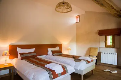 two beds in a room with two beds sidx sidx sidx sidx at Bastide des Tourelles pour 20 pers. Piscine & Spa in Marzens