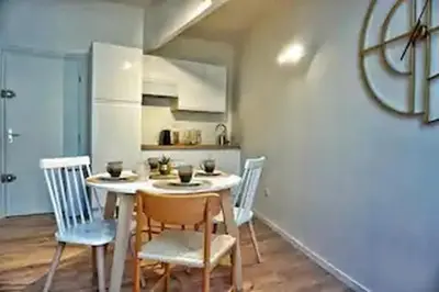a kitchen with a table and chairs in a room at Le Patio in Carcassonne
