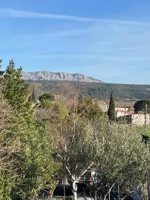 a gravel road next to a stone wall at Les maisons de Gaïa Chambre d'hôte in Tuchan