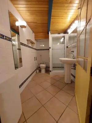 a bathroom with a toilet and a sink at Les maisons de Gaïa Chambre d'hôte in Tuchan