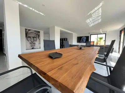 a large wooden table in a room with chairs at La Villa Nina in Mirepeisset