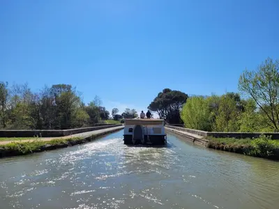 a boat on a river with people on it at La Villa Nina in Mirepeisset