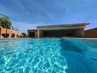 a large swimming pool in front of a building at La Villa Nina in Mirepeisset
