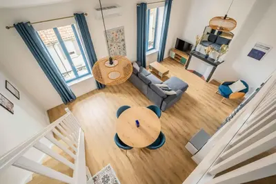 an overhead view of a living room with a couch and a table at L'Apothicaire Proche des Halles in Narbonne